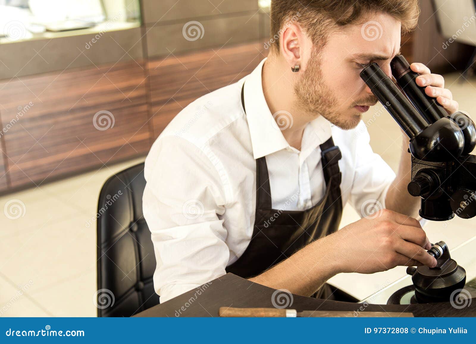 Jeweler Examines the Ring through a Microscope Stock Photo Image of