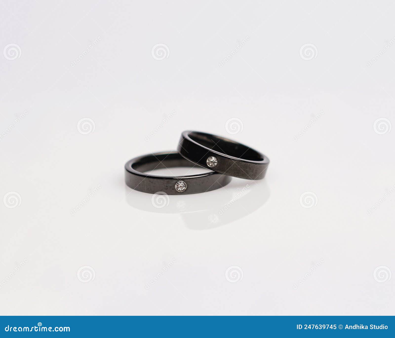 Jewelery ring with diamonds. Wedding rings that have deep meaning and  significance. Engagement ring with gemstones. Wedding ring isolated on  white background, focus blur. Pair in gold, silver, black. 8032249 Stock  Photo