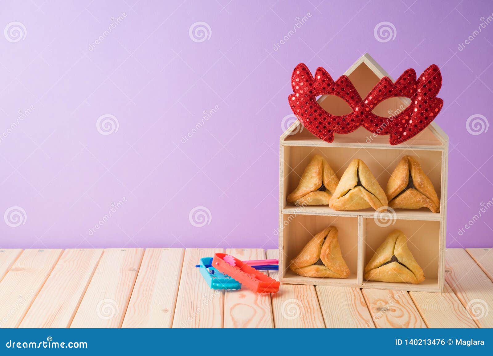 jewish holiday purim background with hamantaschen cookies and toy house on wooden table