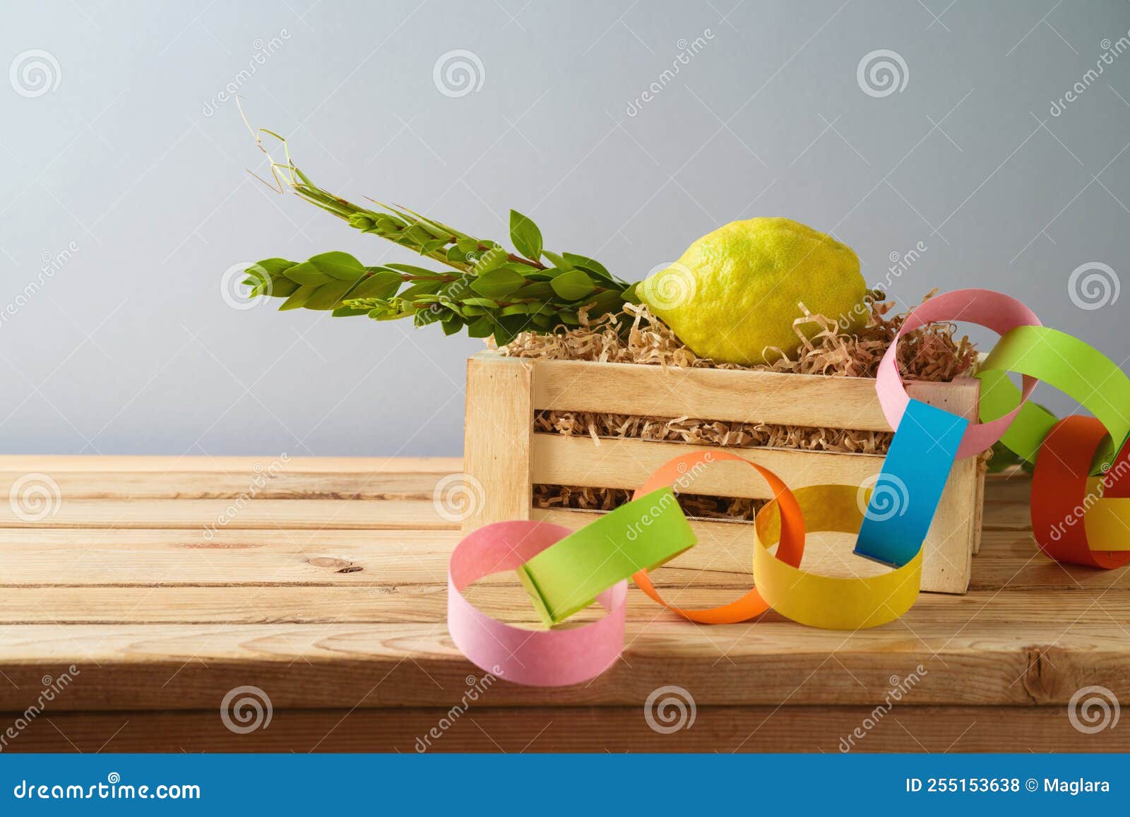 jewish holiday sukkot concept with traditional s and decorations on wooden table over gray background