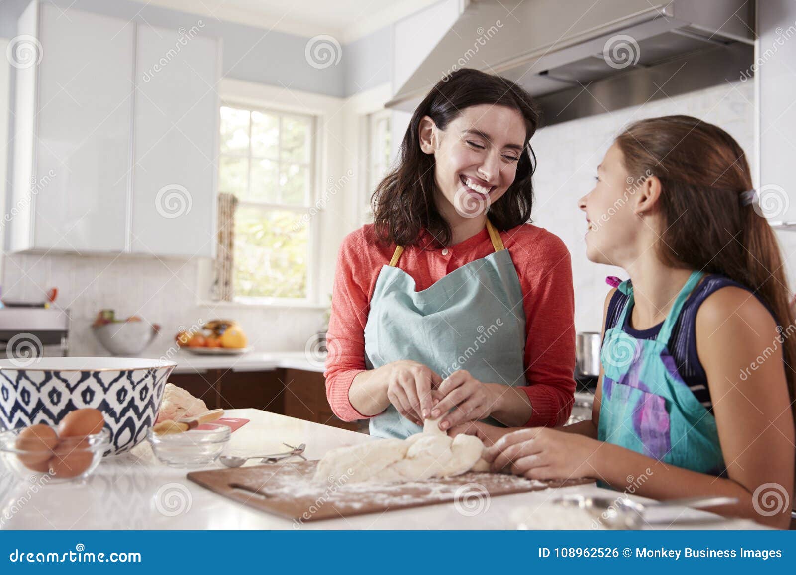 Jewish Mother And Daughter Plaiting Dough For Challah Bread Stock Phot