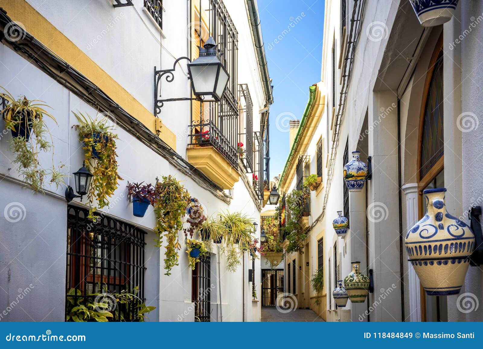 cordoba: old typical street in the juderia with plants and flowers. andalucia, spain.