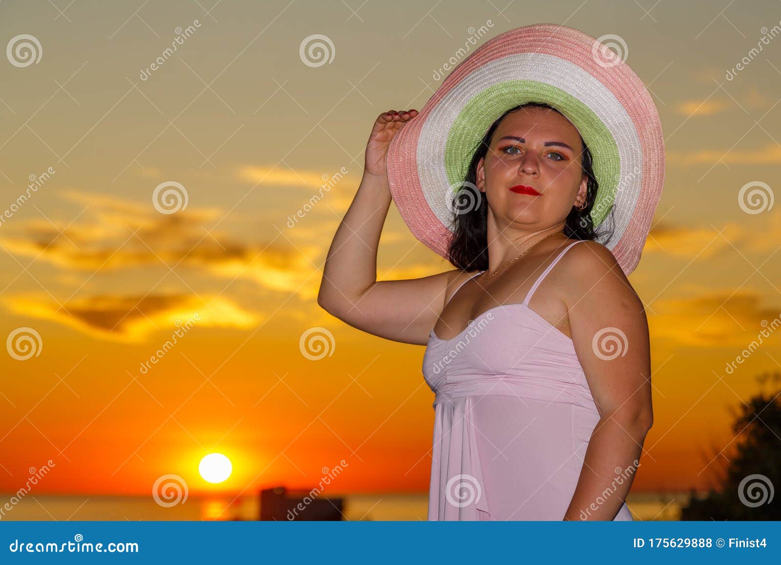 jewish woman in a hat at sunset on a background of the sea.