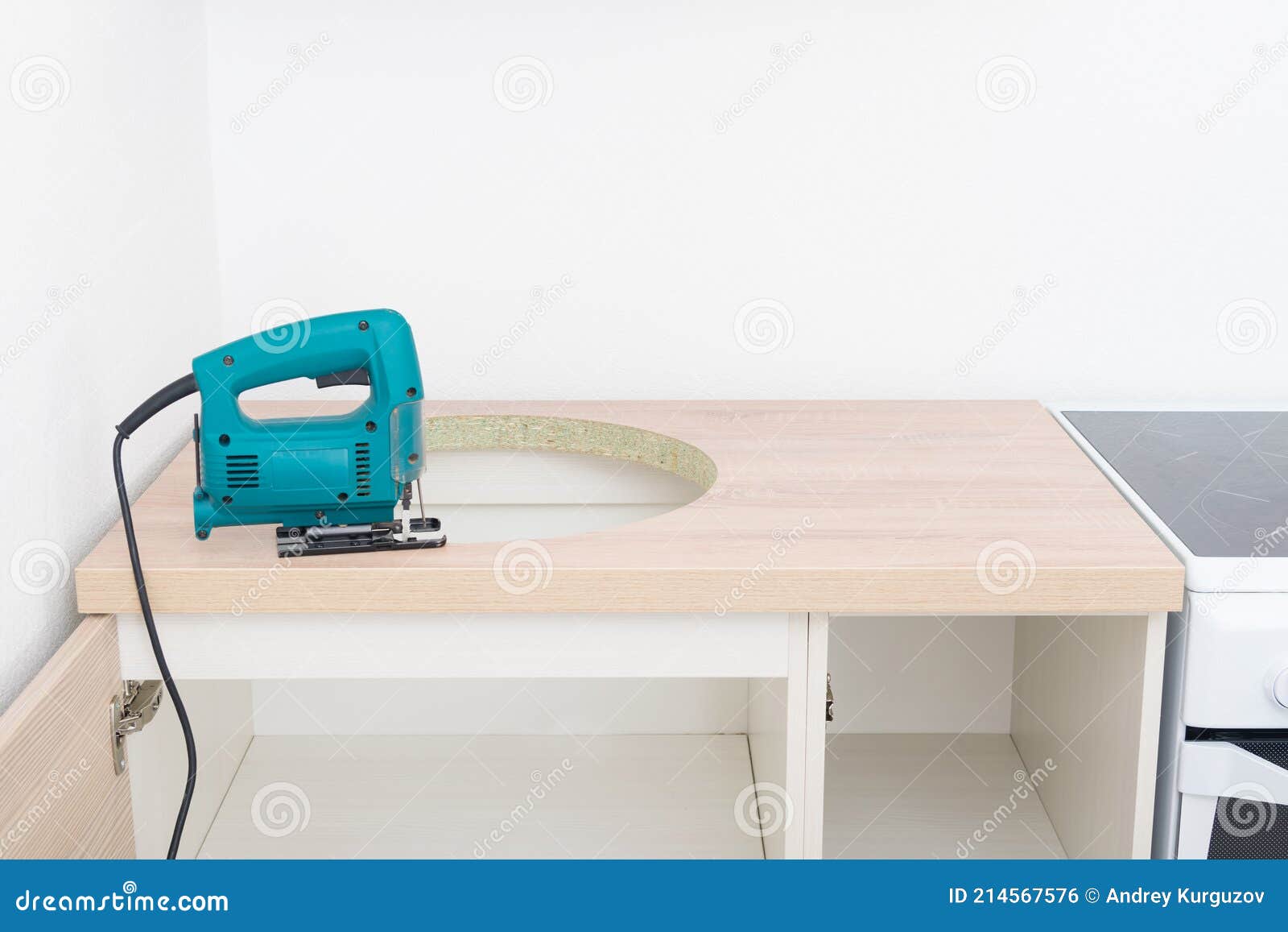 Jigsaw on the Kitchen Countertop in Front of the Cutout Hole for the Sink Stock Photo Image