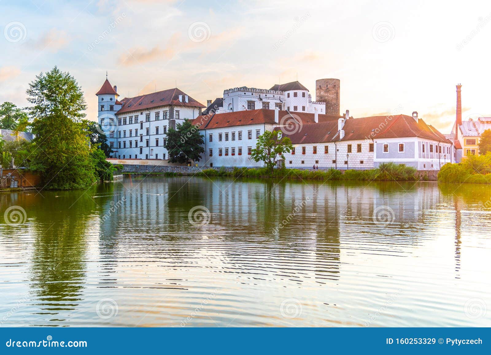 jindrichuv hradec castle at sunset time. reflected in the little vajgar pond, jindrichuv hradec, czech republic