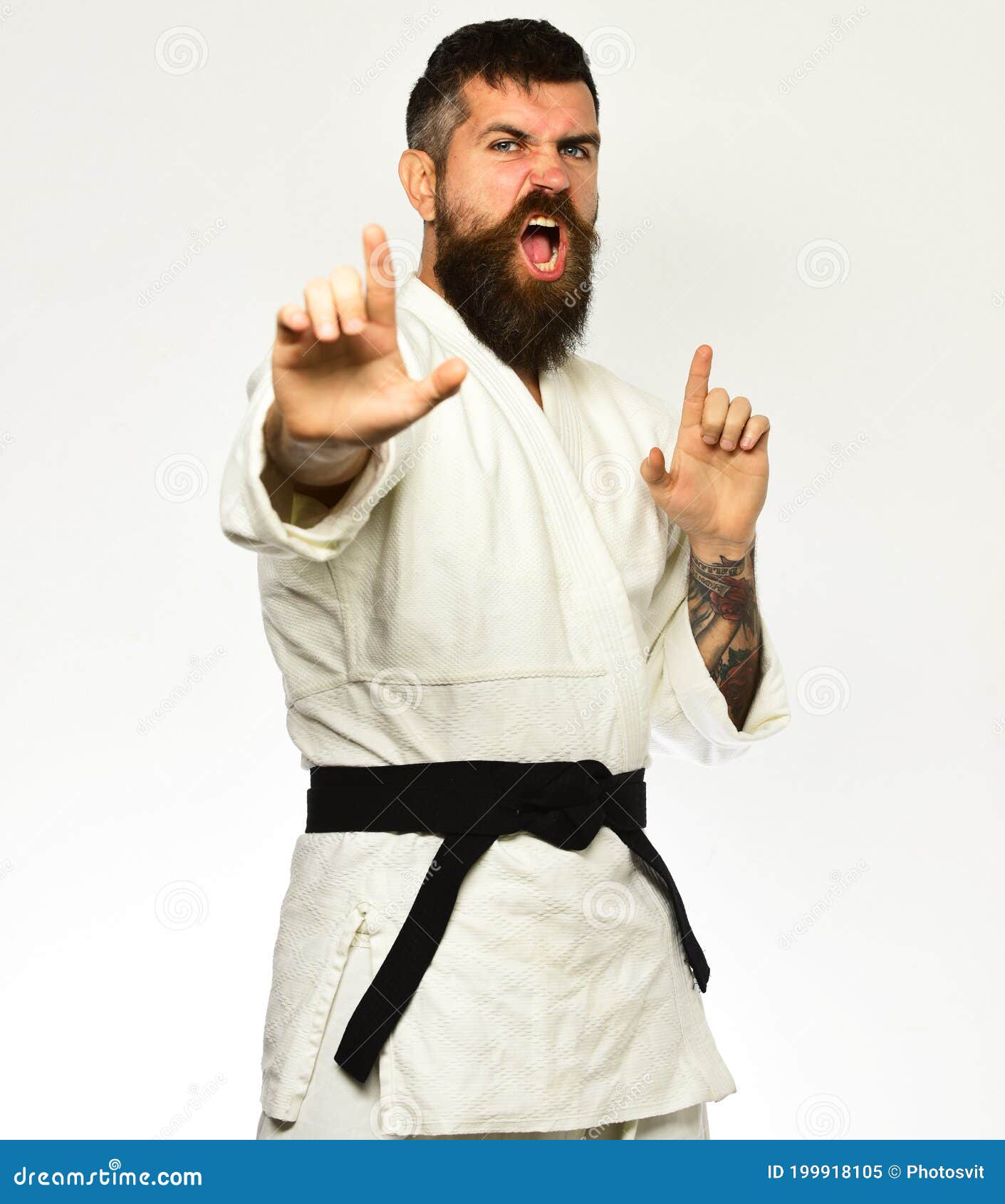 Jiu Jitsu Master with Black Belt Practices Attack, Defense Posture