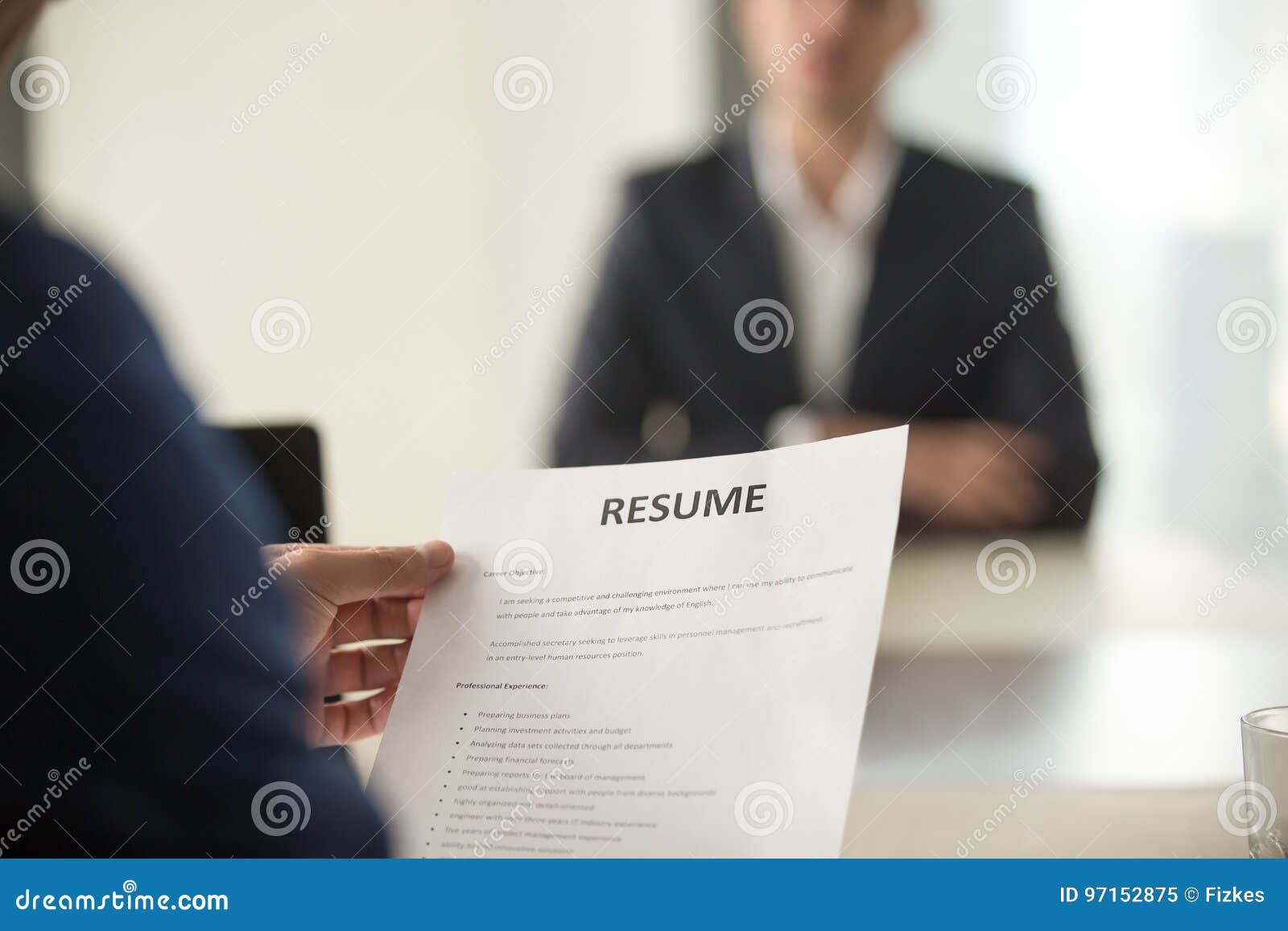 job interview in office, focus on resume, close up view