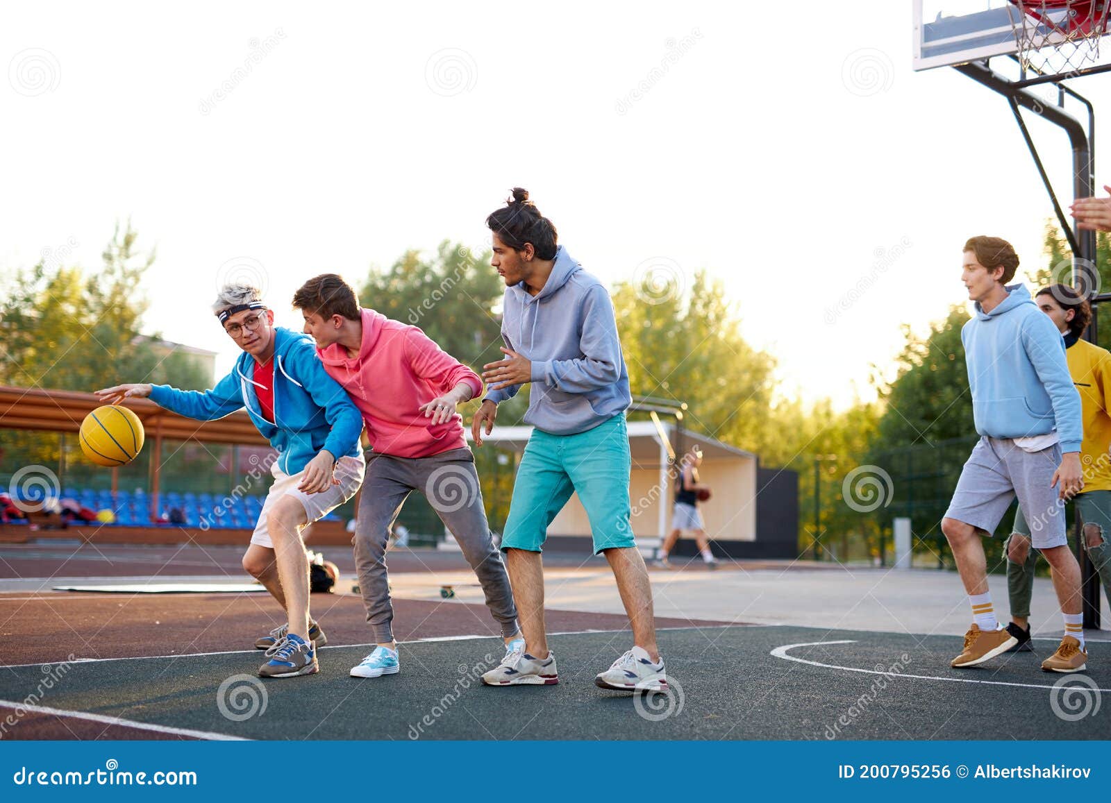 Jovem praticando esportes, jogando basquete ao nascer do sol