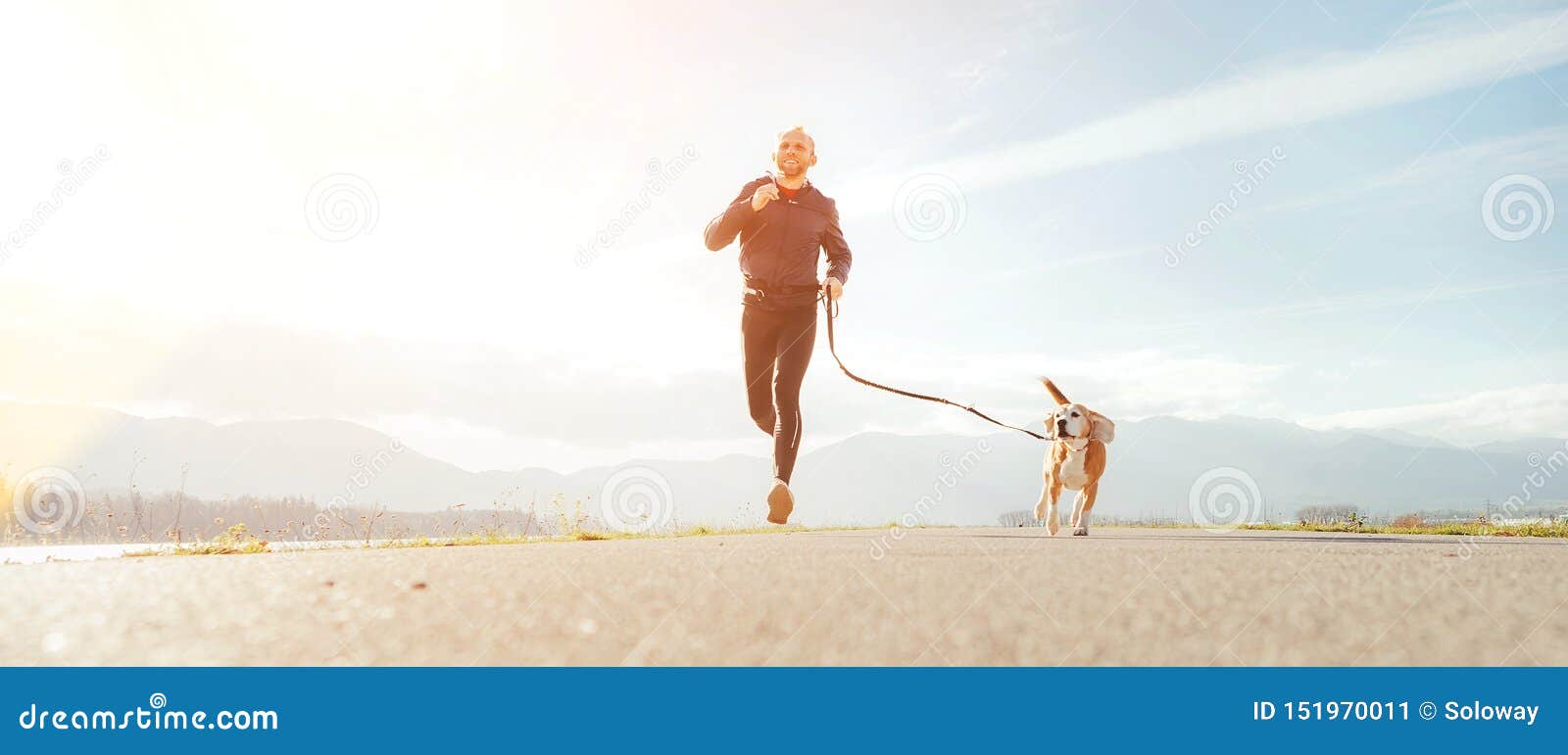 jogging man with his dog in the morning. active healthy lifestyle concept image
