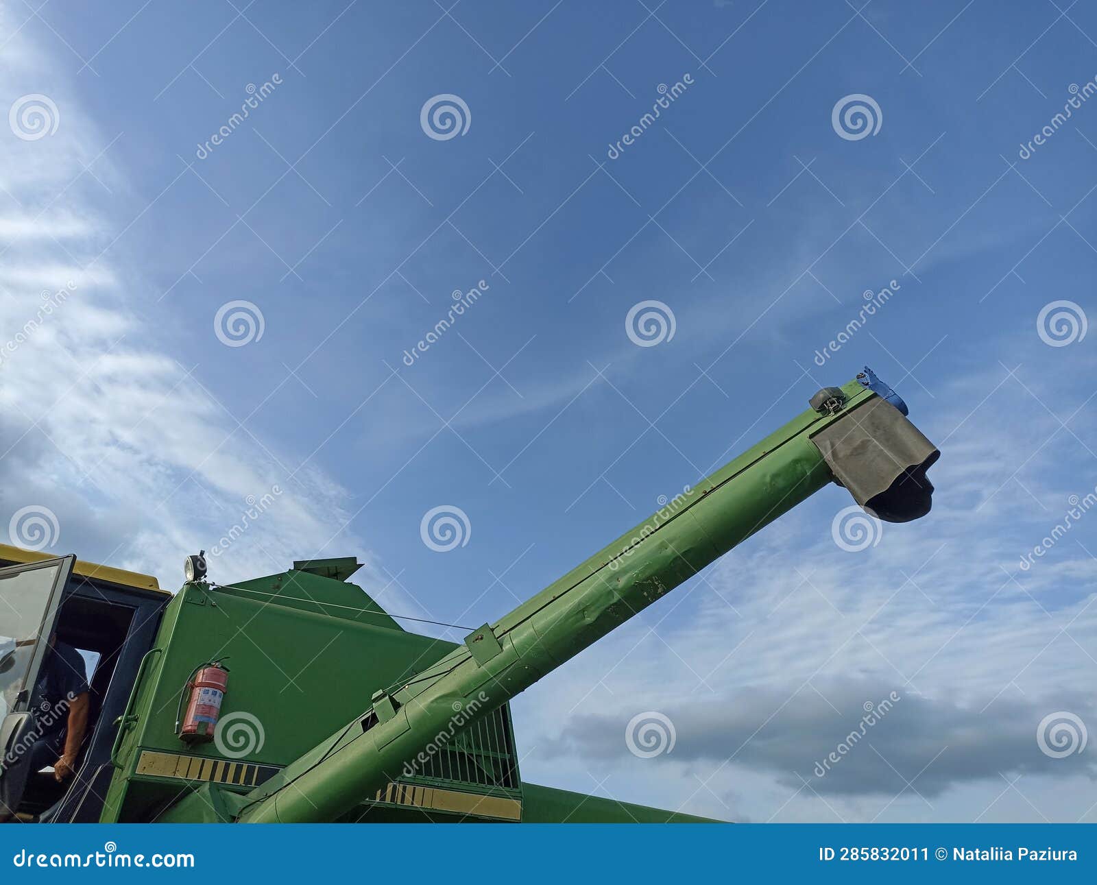 John Deere Harvester Works in the Field. Combine Harvesting Wheat