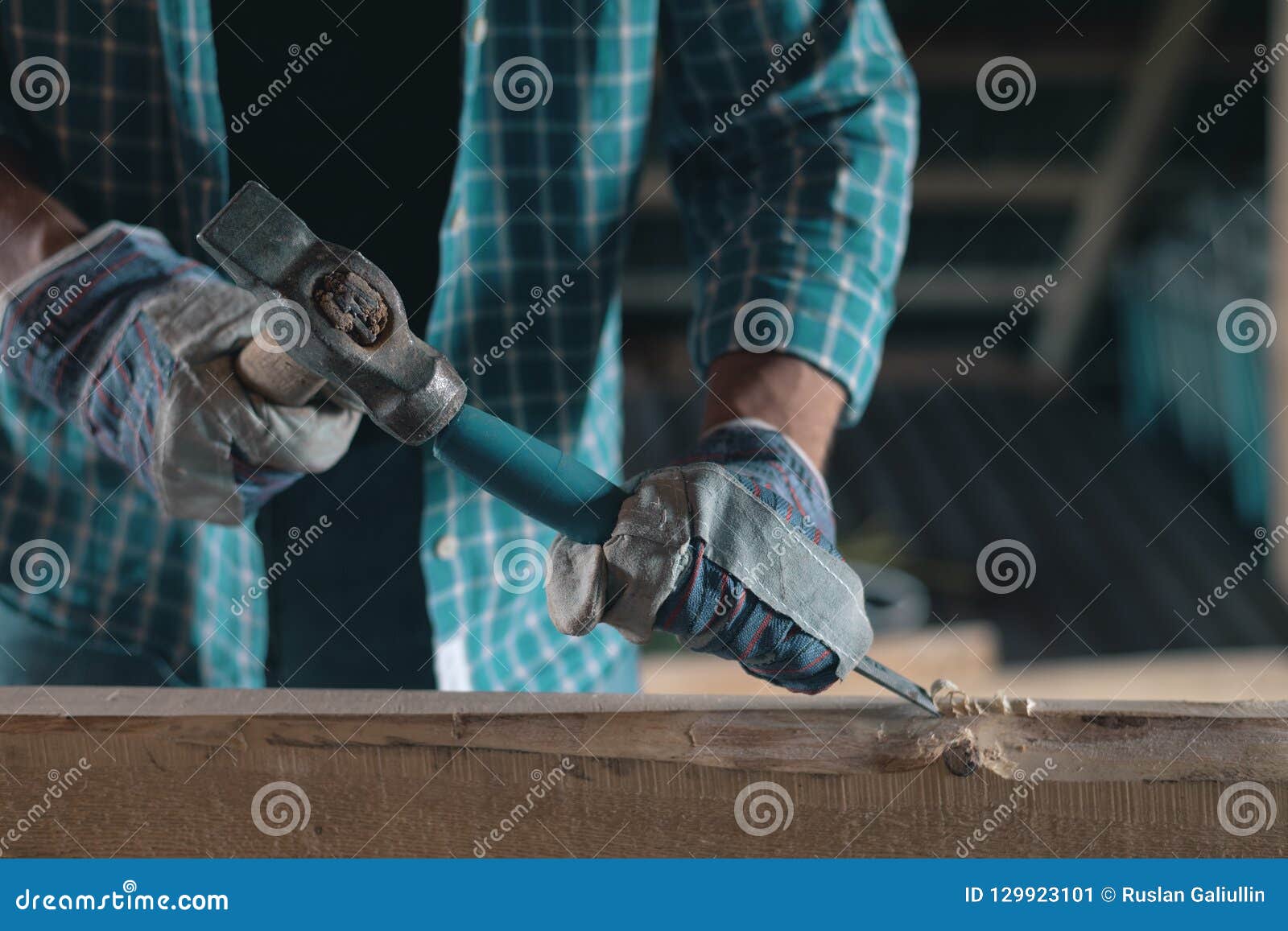 Joiner at Work in a Woodworking Carpenter with a Hammer and