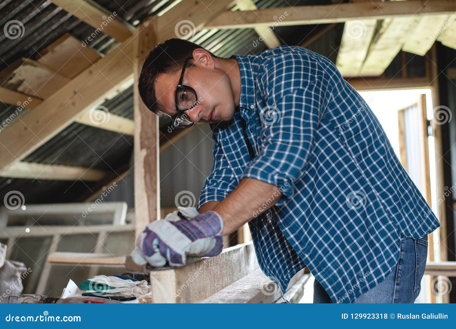 Joinery. the Carpenter Planes the Wood in the Woodworking, Roofing, Diy. Stock Photo