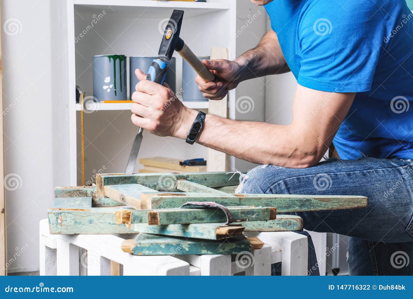 joinery: furniture master restores the old, dilapidated stool. closeup of a man`s hand.