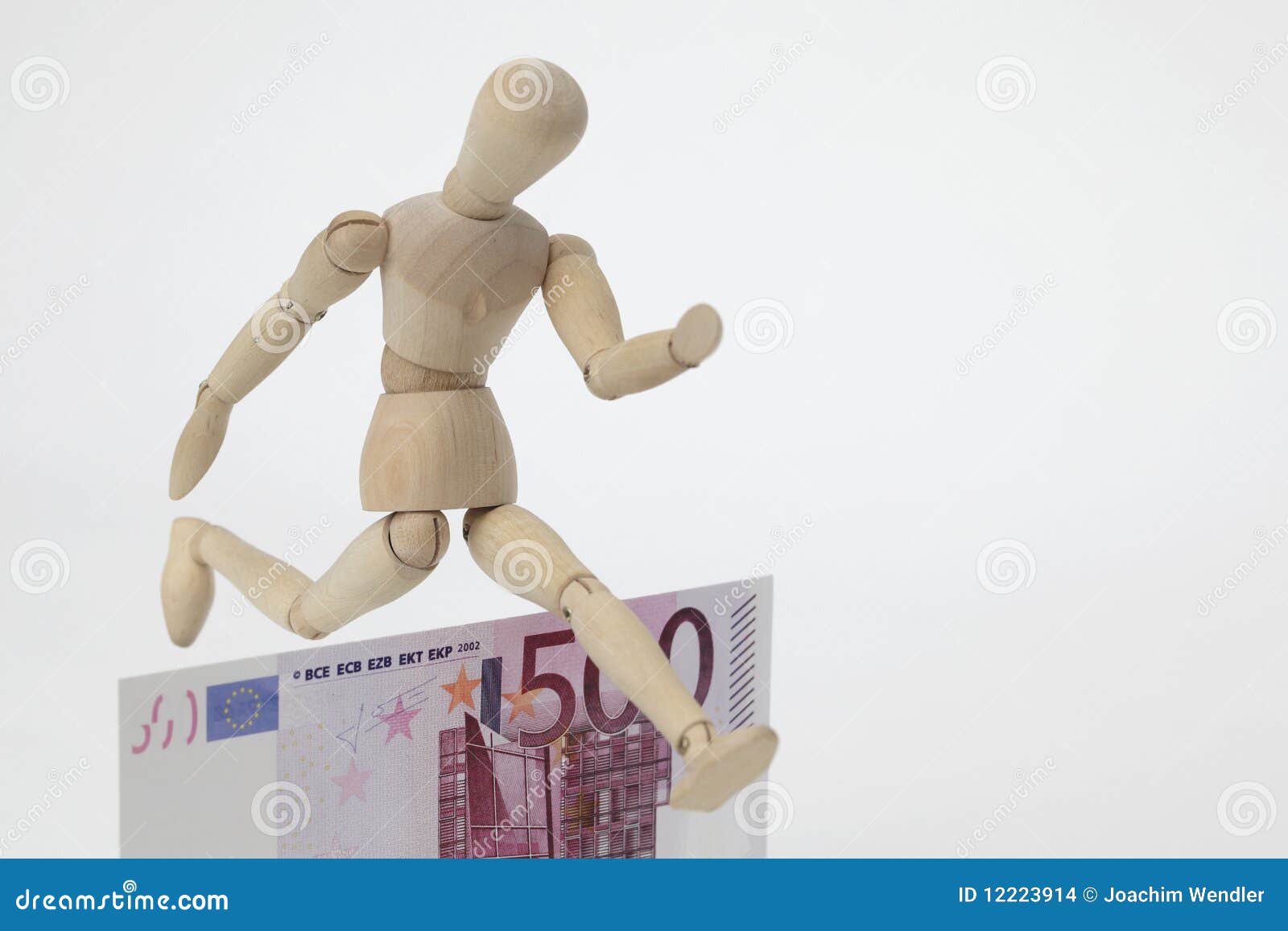 jointed doll jumping over a 500-euro-banknote