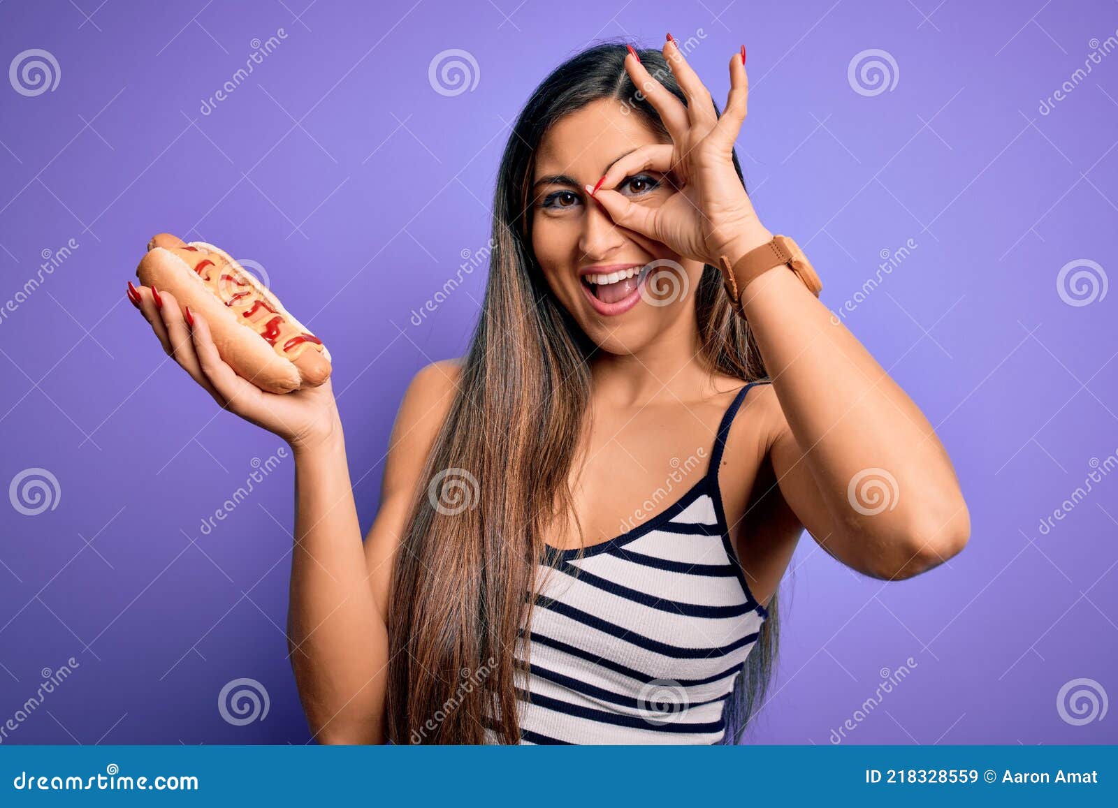 Jonge Vrouw Die Hotdog Eet Met Ketchup En Mosterd Over Paarse Achtergrond Met Een Blij Gezicht Glimlachend En Met De Hand Op De Og Stock Afbeelding - Image Of Vriendschappelijk, Ogen: 218328559