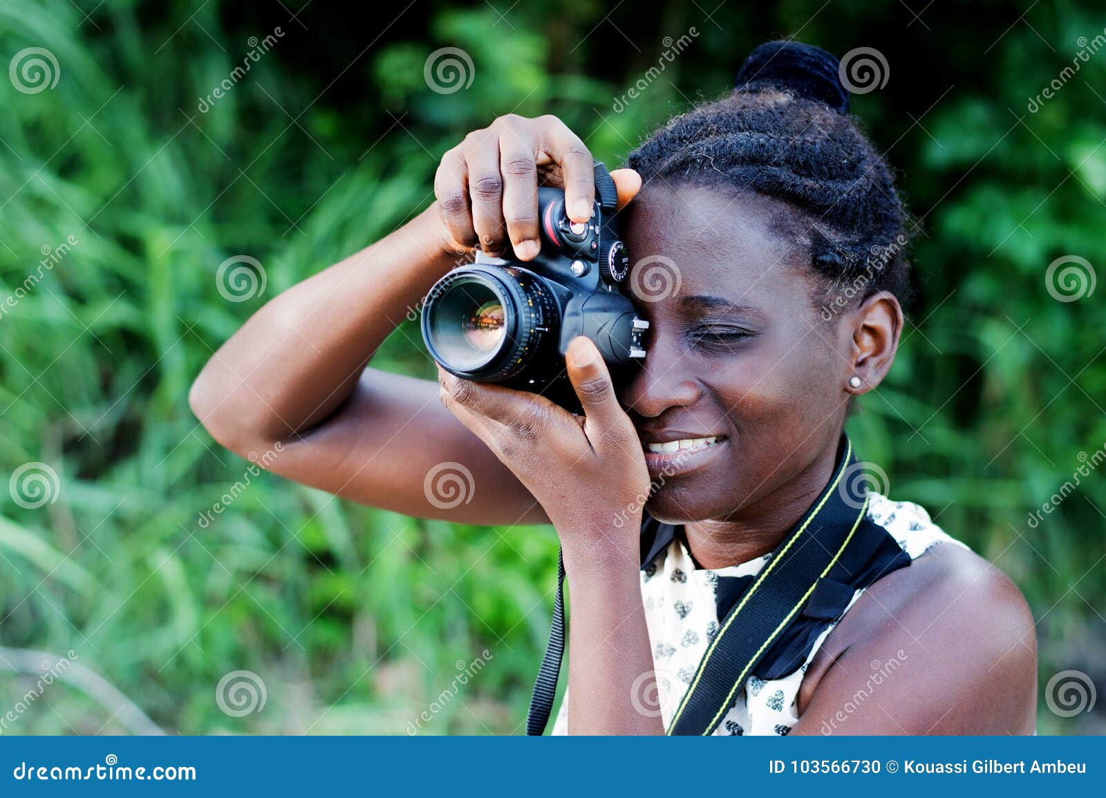 Jonge vrouwelijke fotograaf die beelden nemen. Reis, toerisme en hobby Jonge vrouwenfotograaf die beelden in de struik nemen