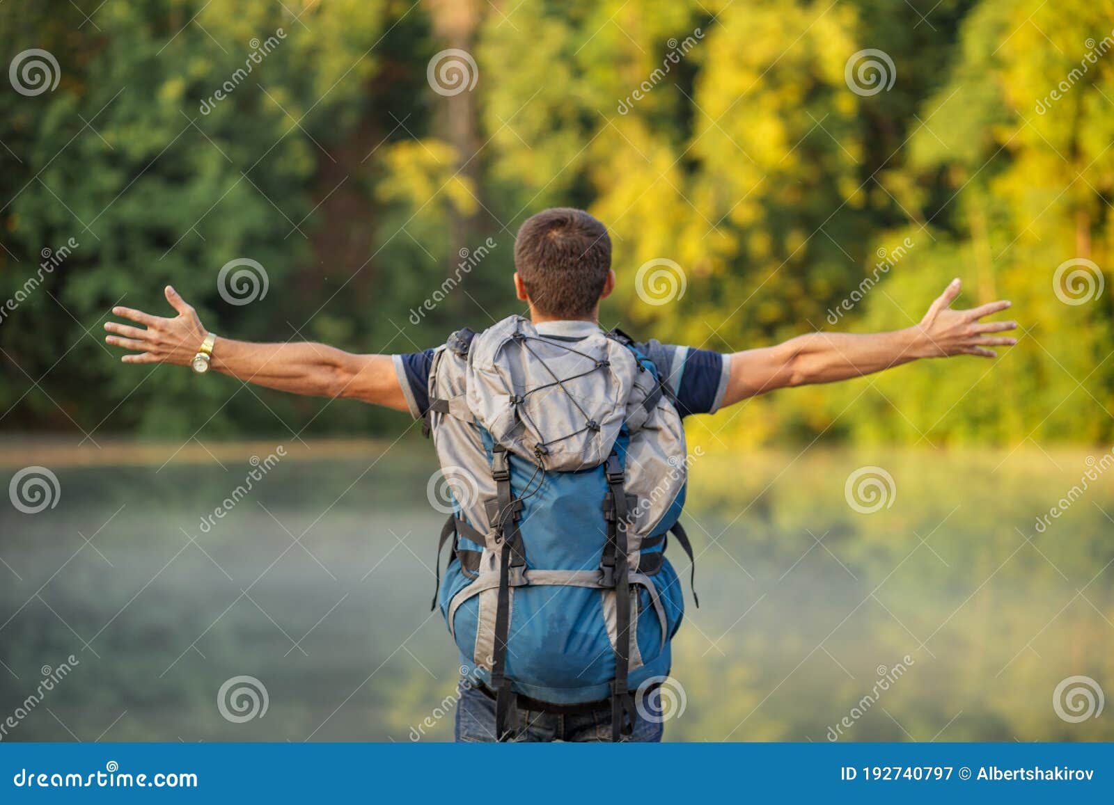 jouful hiker is trying to hug the space, nature as he is romantic