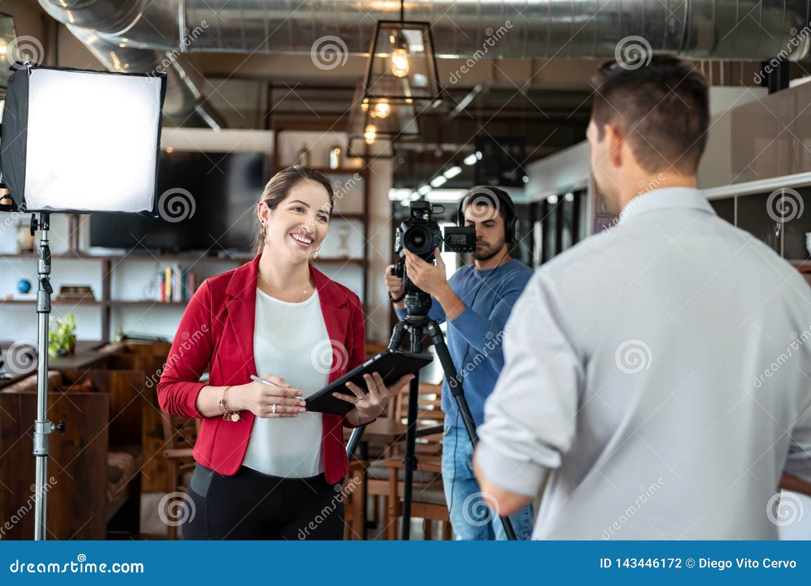 journalist interviewing business man in conference room for broadcast