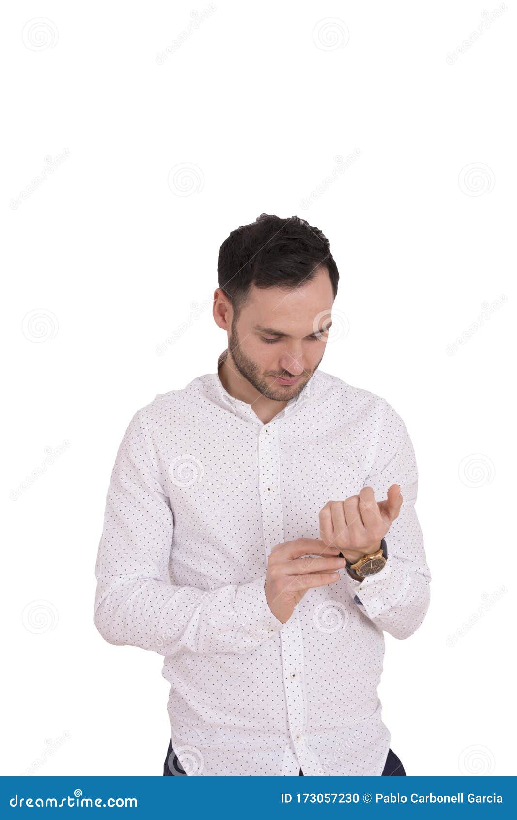 portrait of a handsome young man tying his shirt