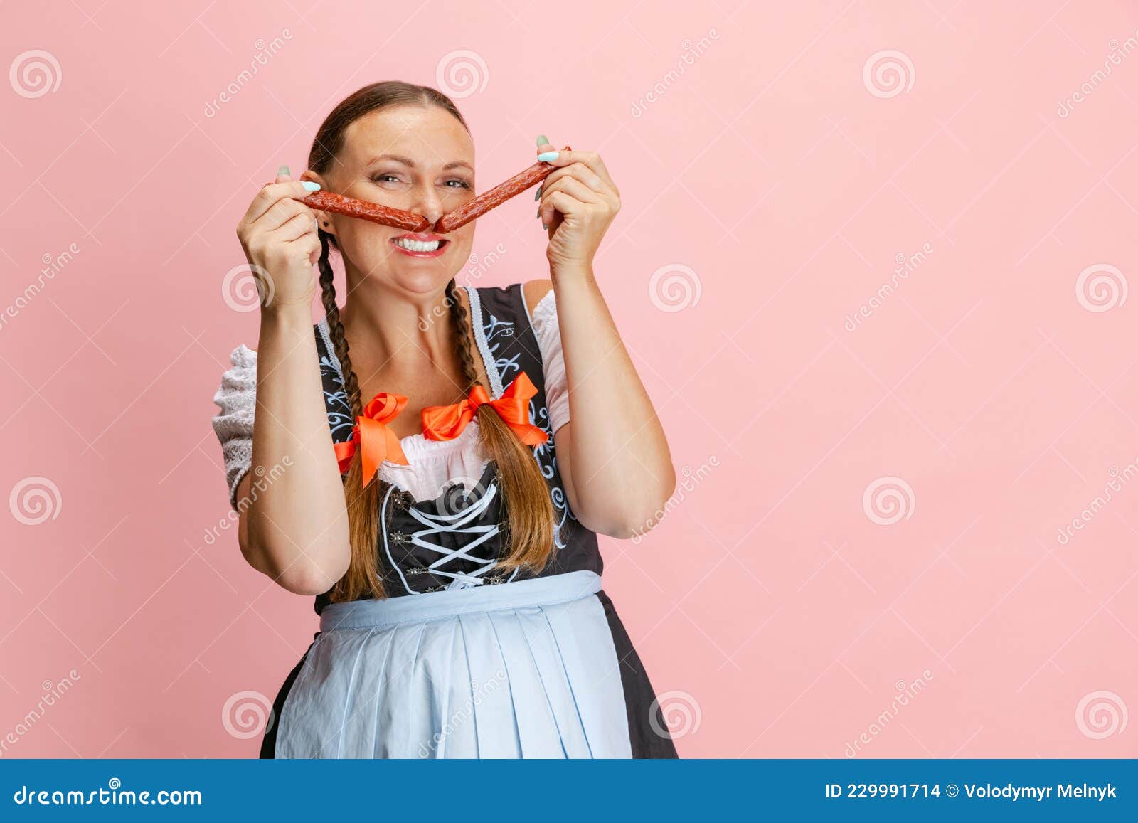 Cute Pretty Oktoberfest Woman Waitress Wearing A Traditional Bavarian Or German Dirndl Having