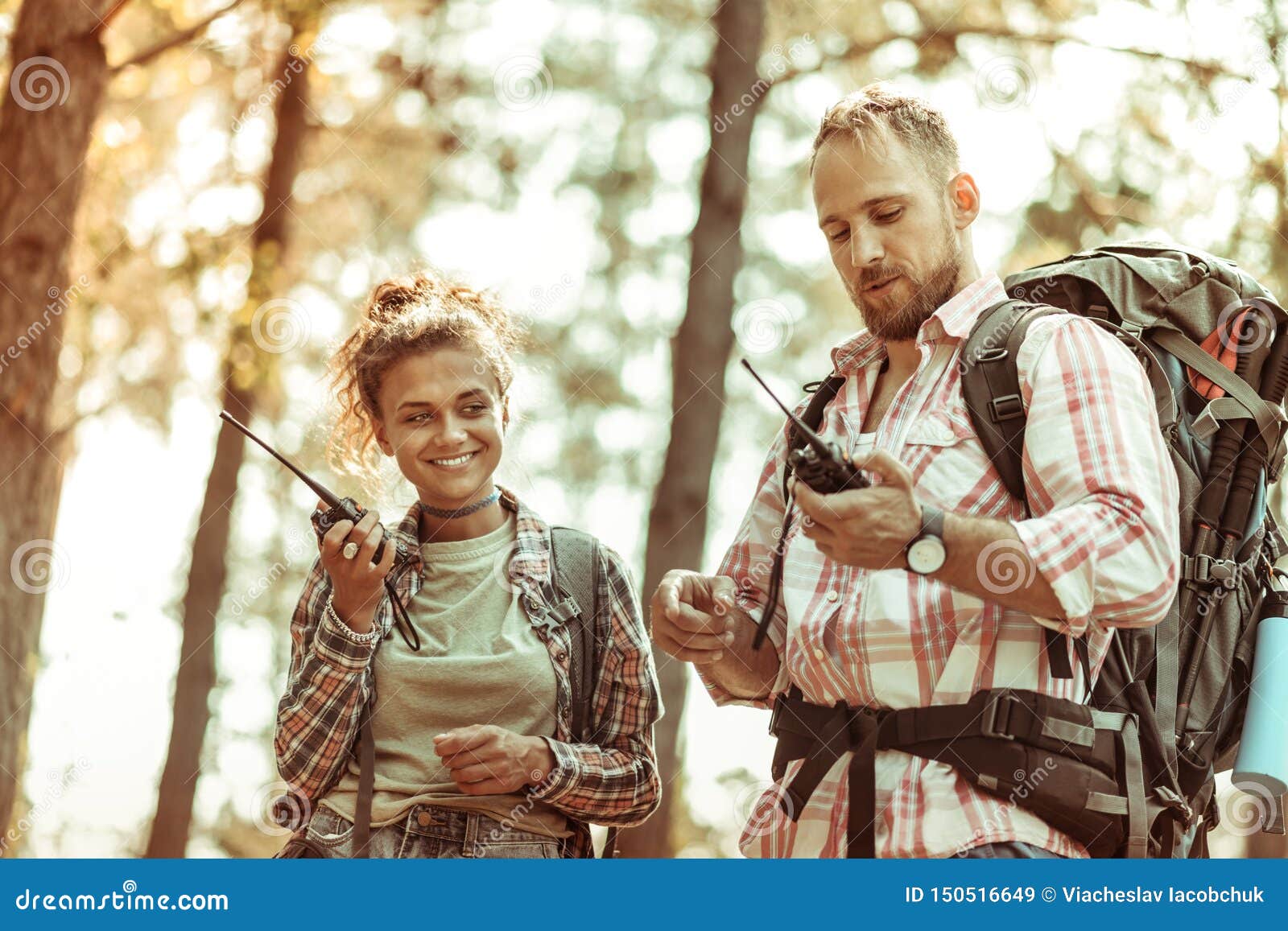 joyful active couple speaking on walkie talkies