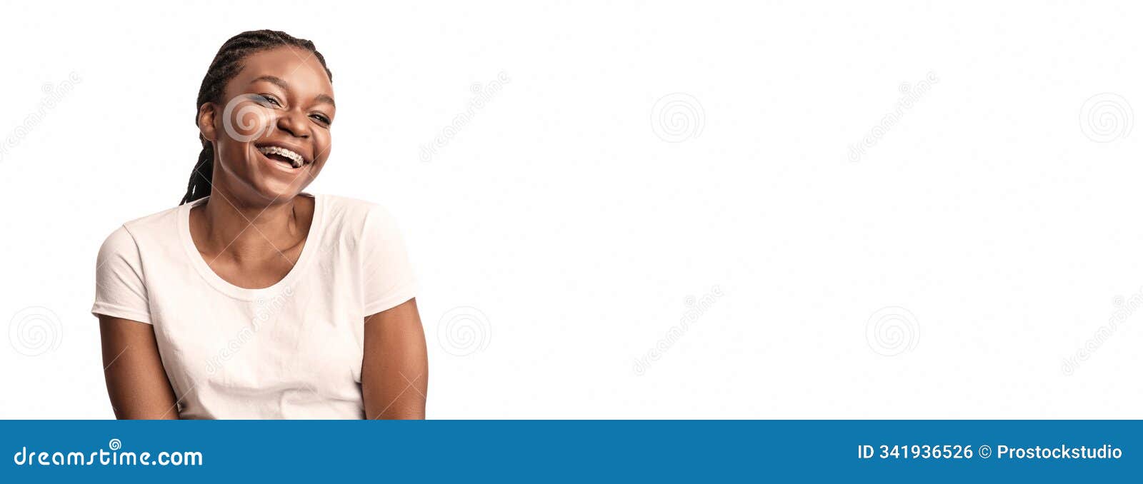 joyful african lady with orthodontic braces laughing posing in studio