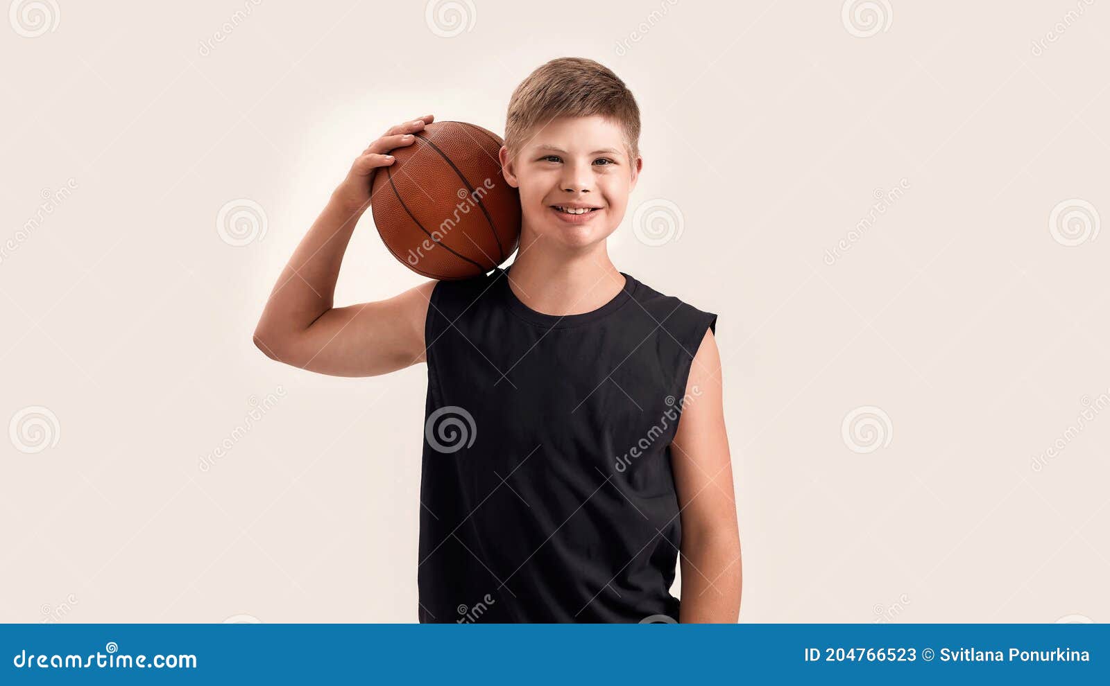 Joyful Disabled Boy With Down Syndrome Smiling At Camera While Posing