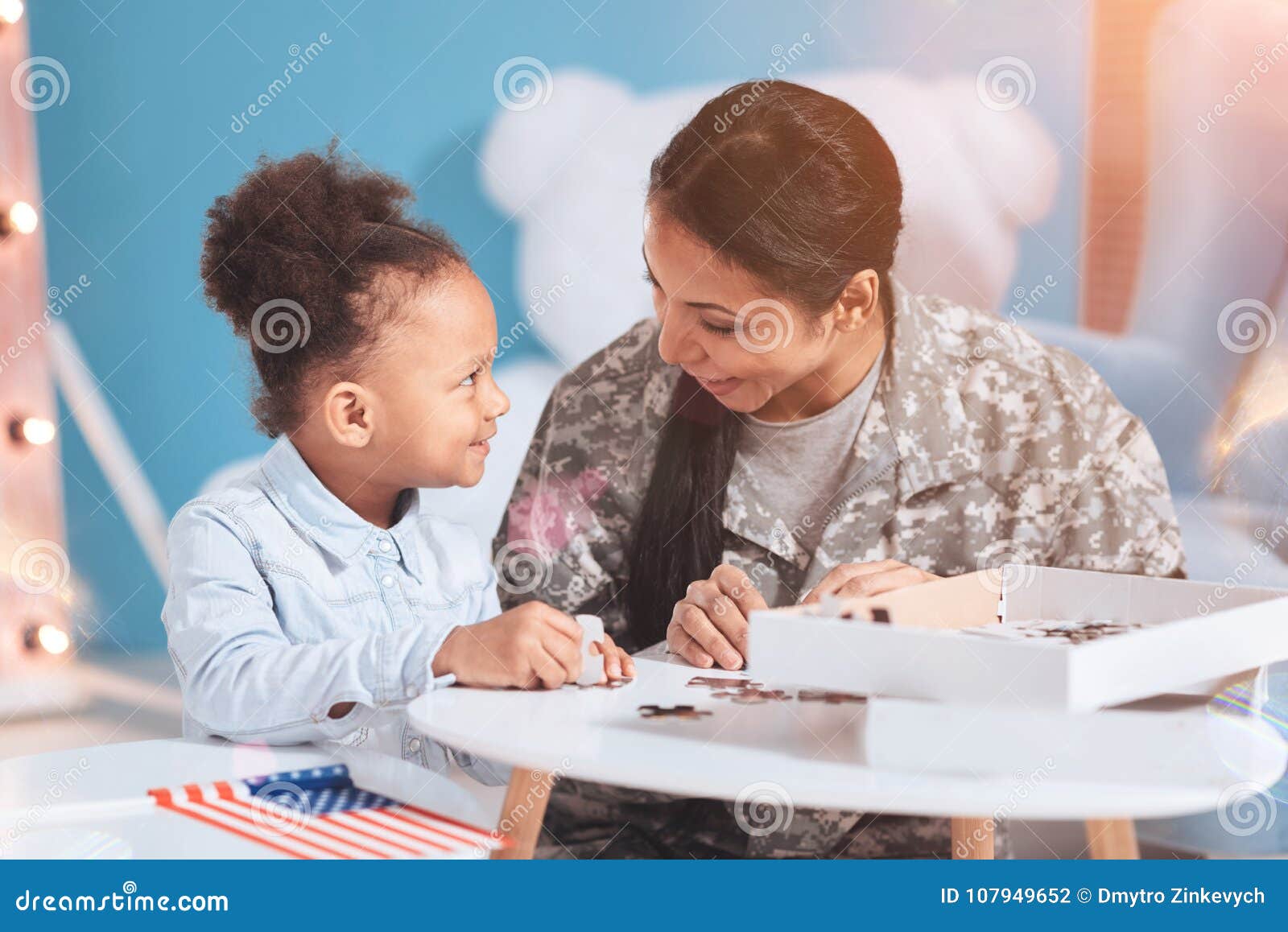Joyful Happy Mother and Daughter Doing Jigsaw Puzzle Stock Photo