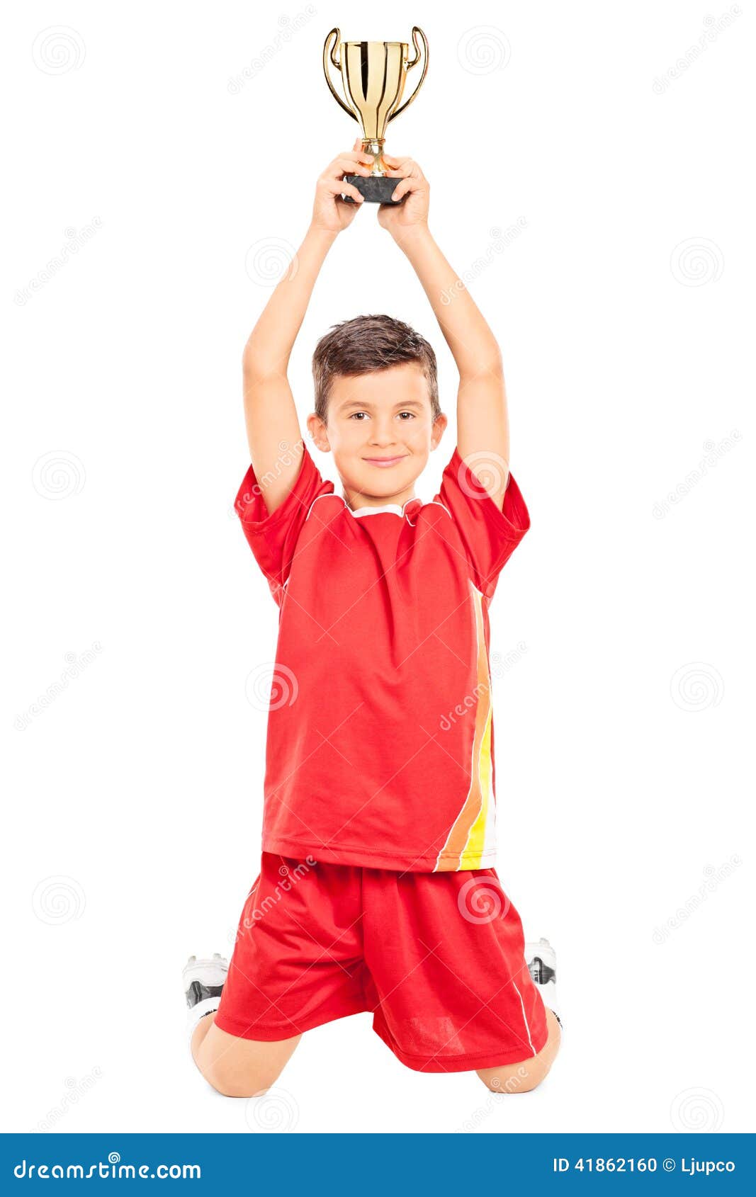 Joyful Little Boy Holding a Trophy Above His Head Stock Photo - Image ...