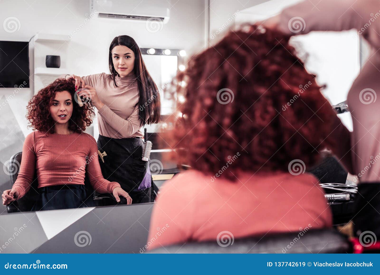 joyful positive woman visiting a hair stylist