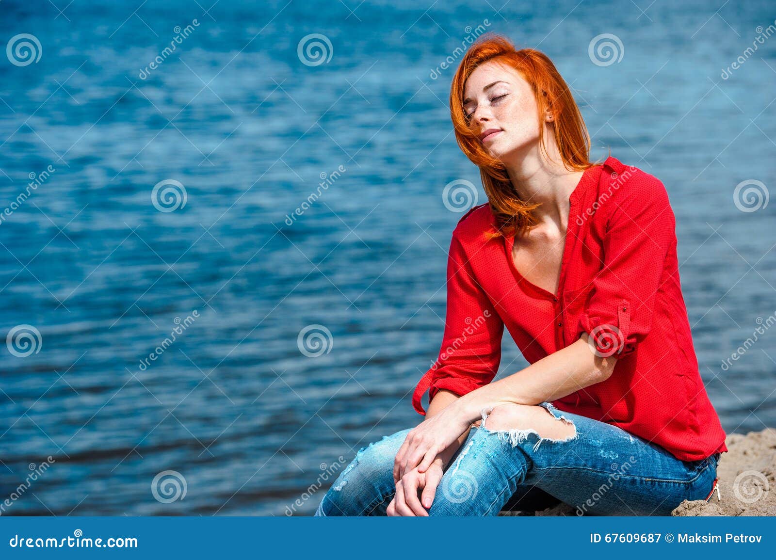 joyful serene redhead woman sitting comfortably