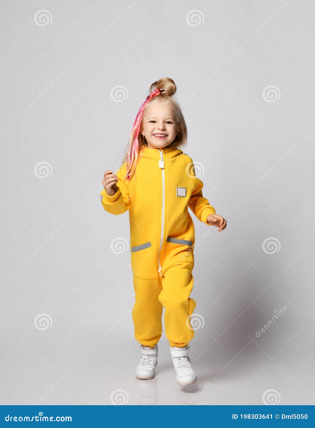 Cheerful Blonde Kid Baby Girl with Colorful Braids in Stylish Yellow  Jumpsuit and Sneakers Runs Jumps Towards Camera Stock Image - Image of  beauty, cool: 198303641