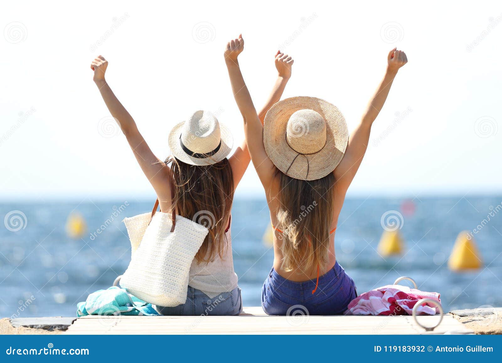 joyful tourists on summer vacations on the beach