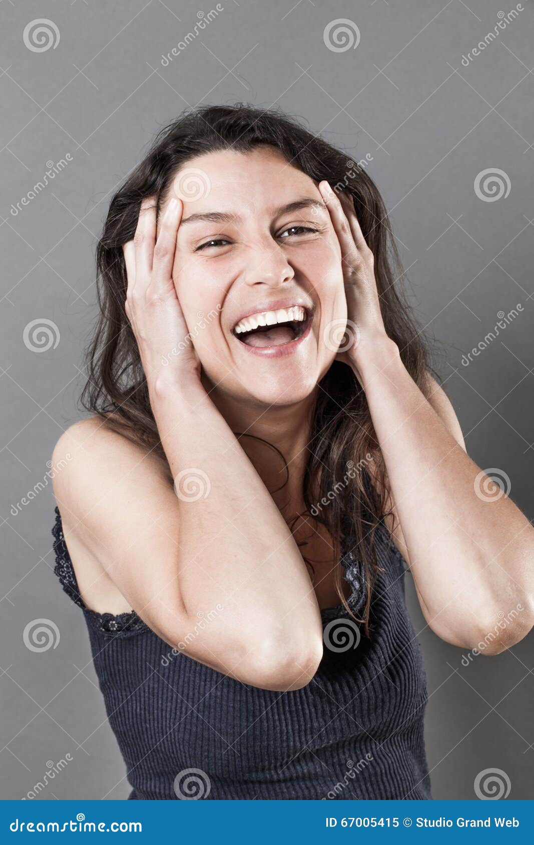 joyous young woman bursting out laughing