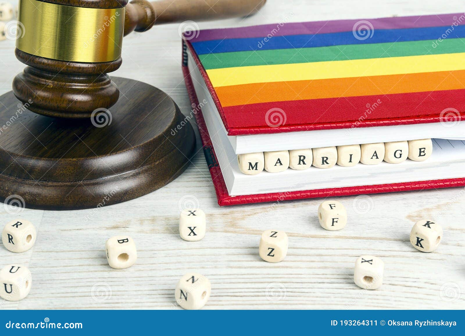 judge gavel with word marriage in wooden blocks in red notebook and rainbow lgbt flag on wooden table