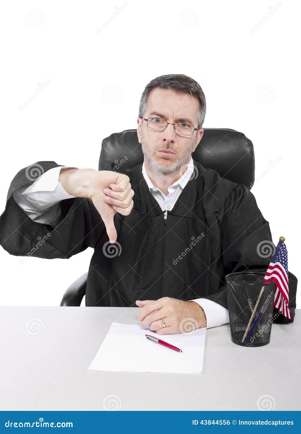 Middle aged caucasian american judge in a robe sitting