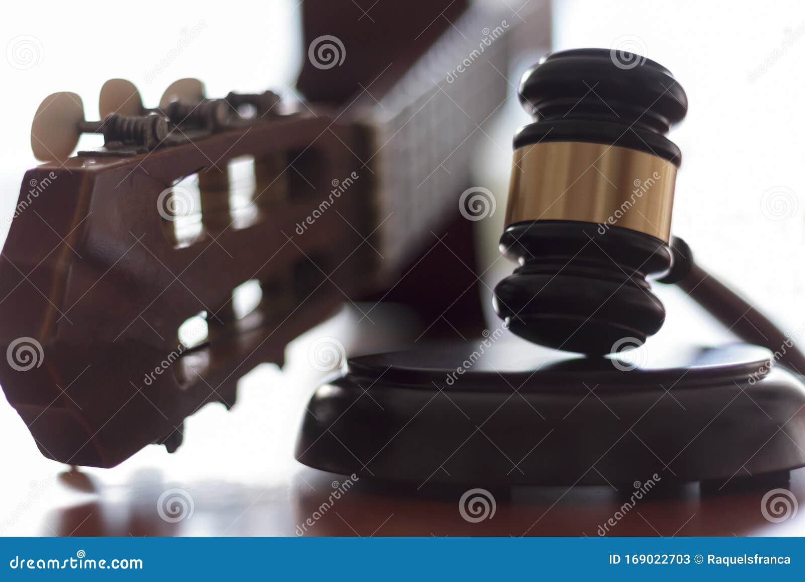 judge`s gavel and guitar. concept of entertainment lawsuit, music piracy and copyright protection