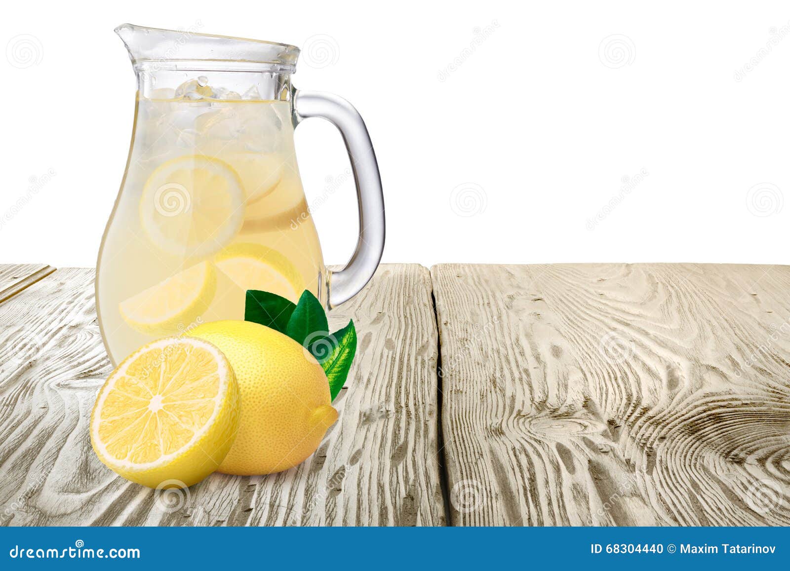 jug or pitcher of lemonade with lemons on foreground standin on