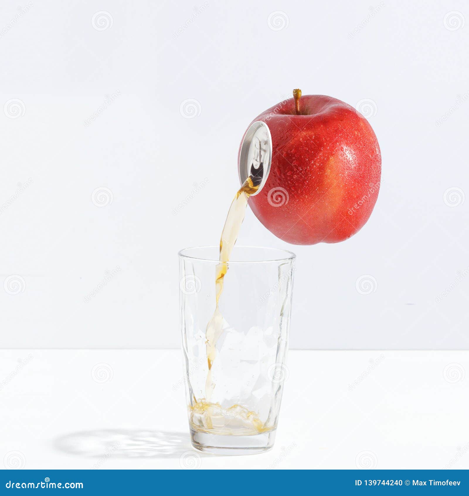 Juice Flowing from a Ripe Apple into a Glass. Creative Concept of Fresh
