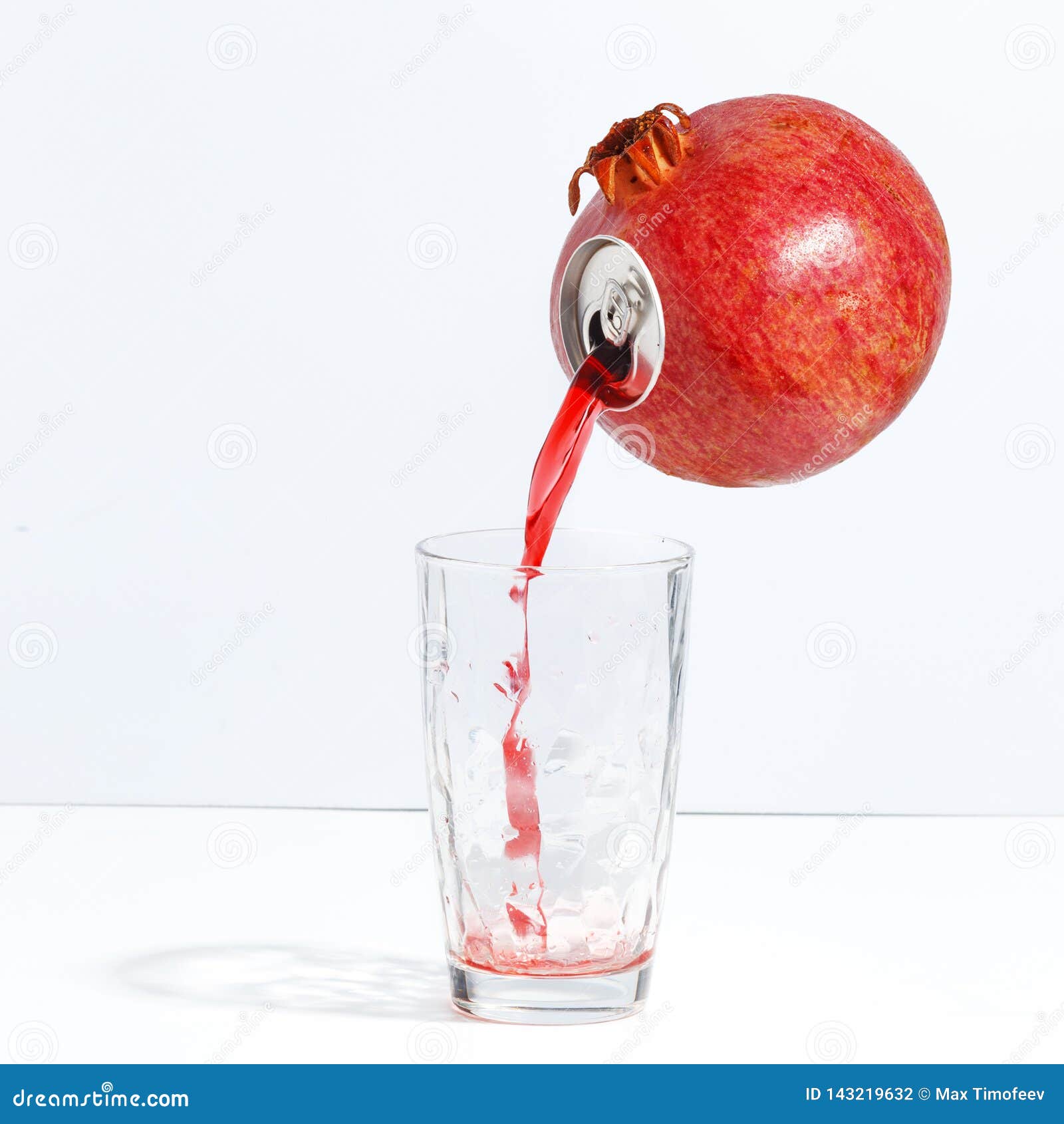 Juice Flowing from a Ripe Pomegranate into a Glass. Creative Concept of Fresh Juice Stock Photo