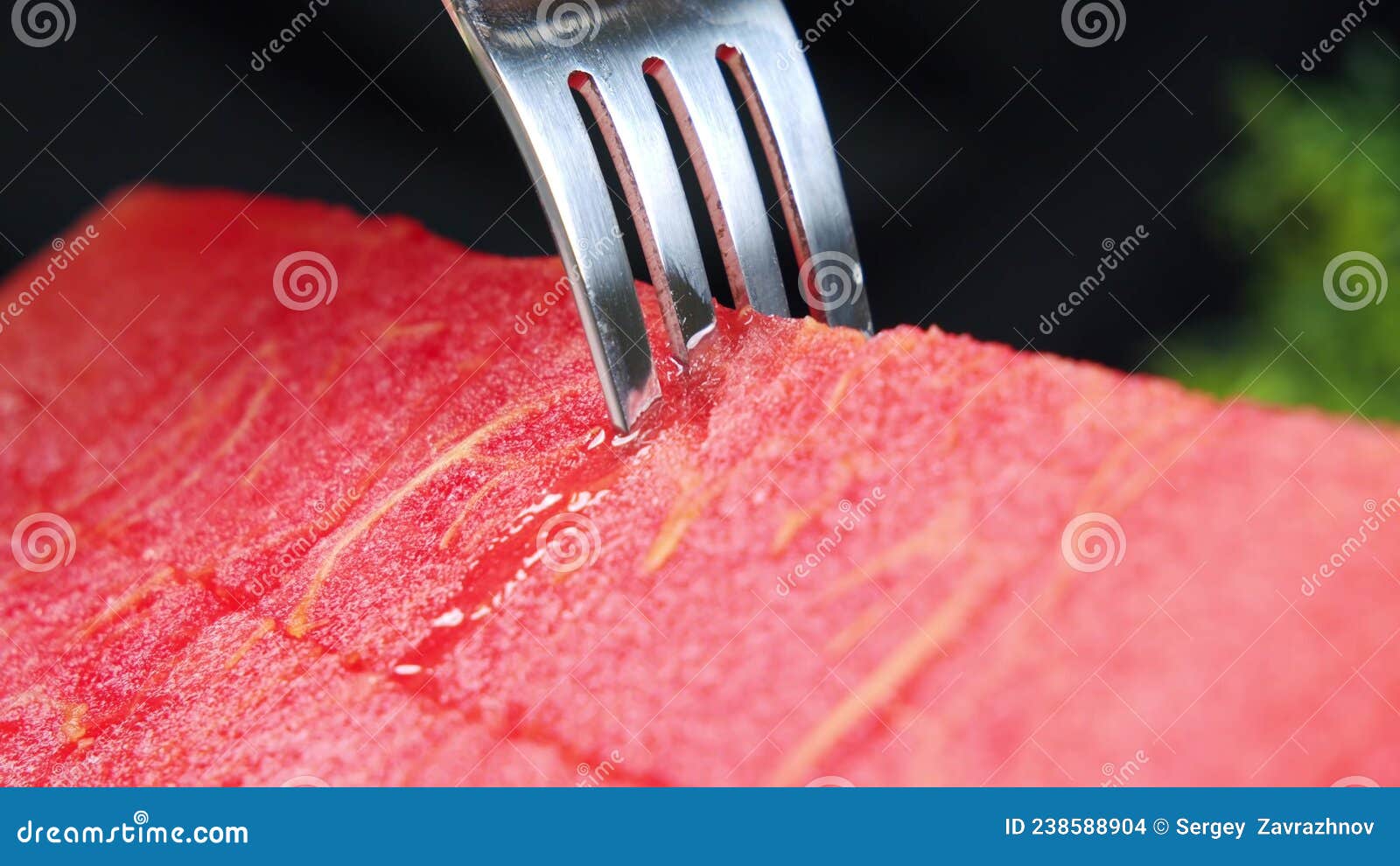 Juicy Fresh Watermelon, Sliced by Hand on a Board with a Kitchen Knife