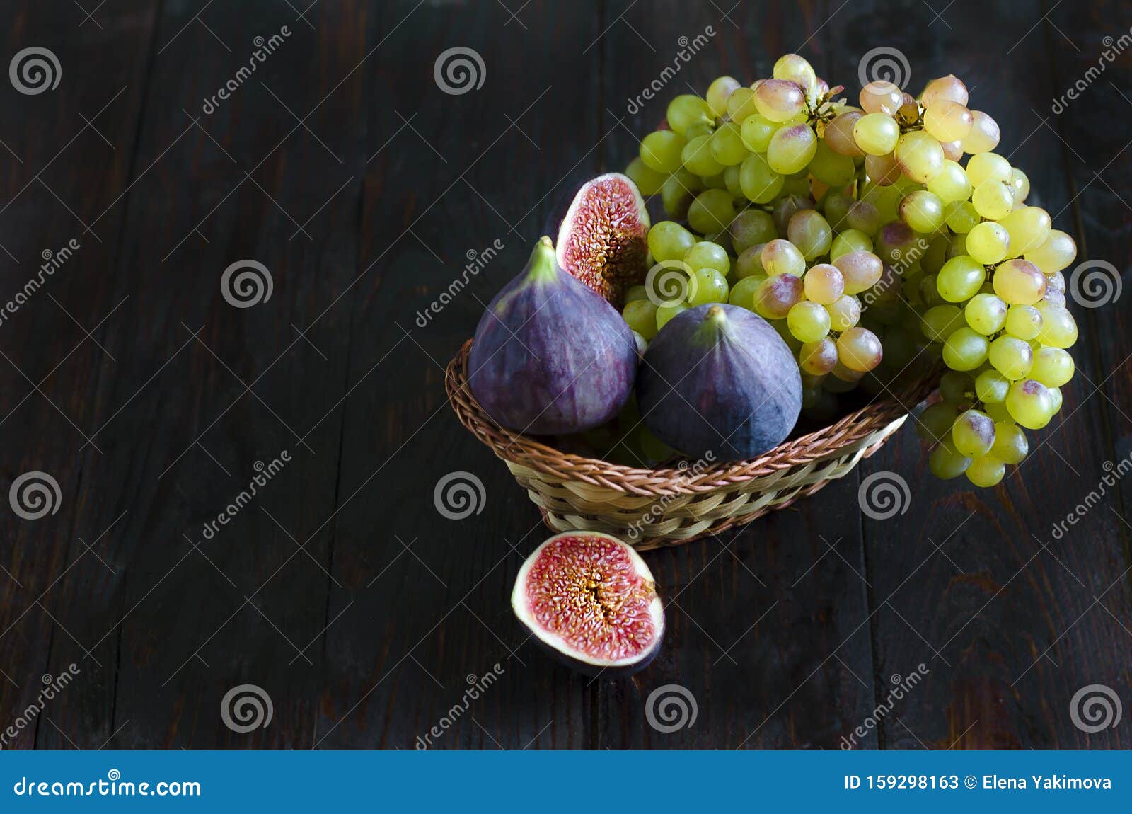 Juicy Raisins and Several Ripe Figs in a Fruit Basket on a White and ...