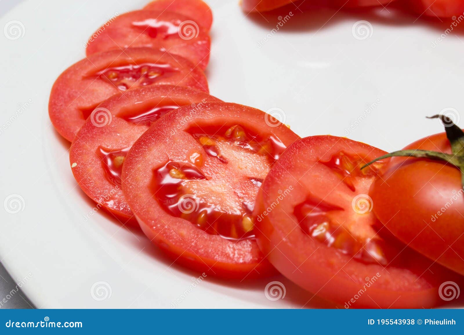 juicy red tomatoes in table cloth . caro background