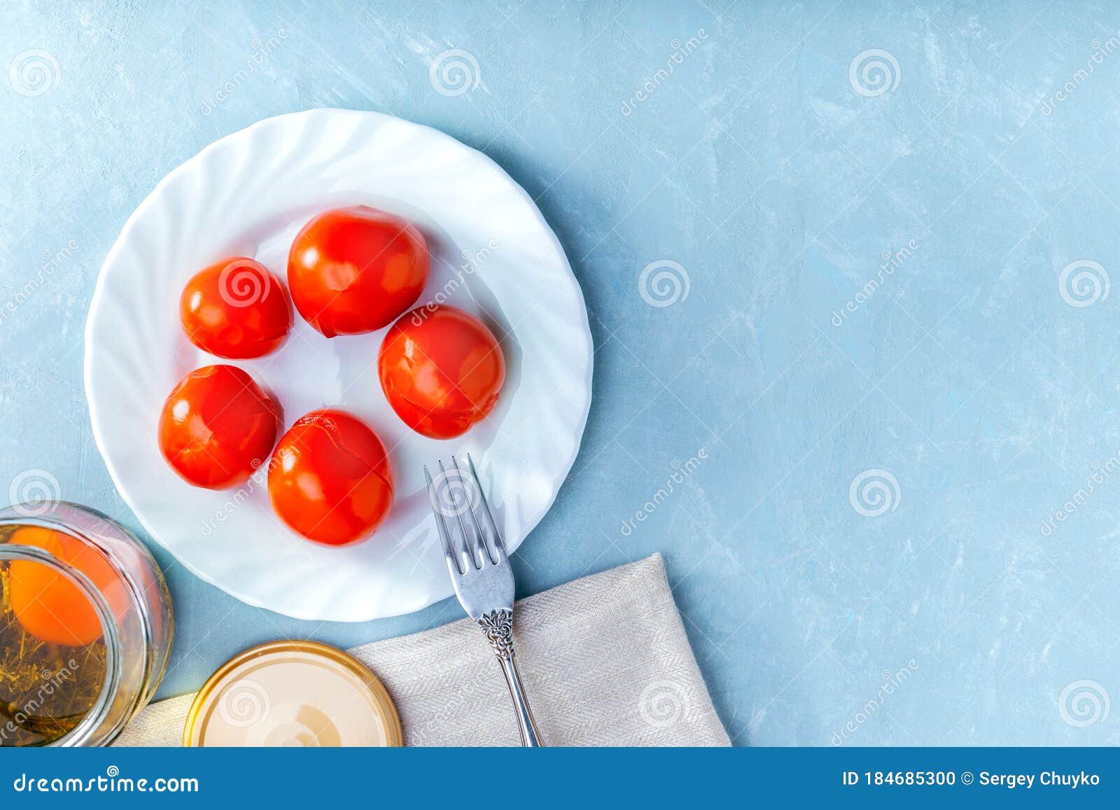 Juicy Spicy Marinated Tomatoes on a White Plate on Blue Surface. Top View Stock Photo Image of