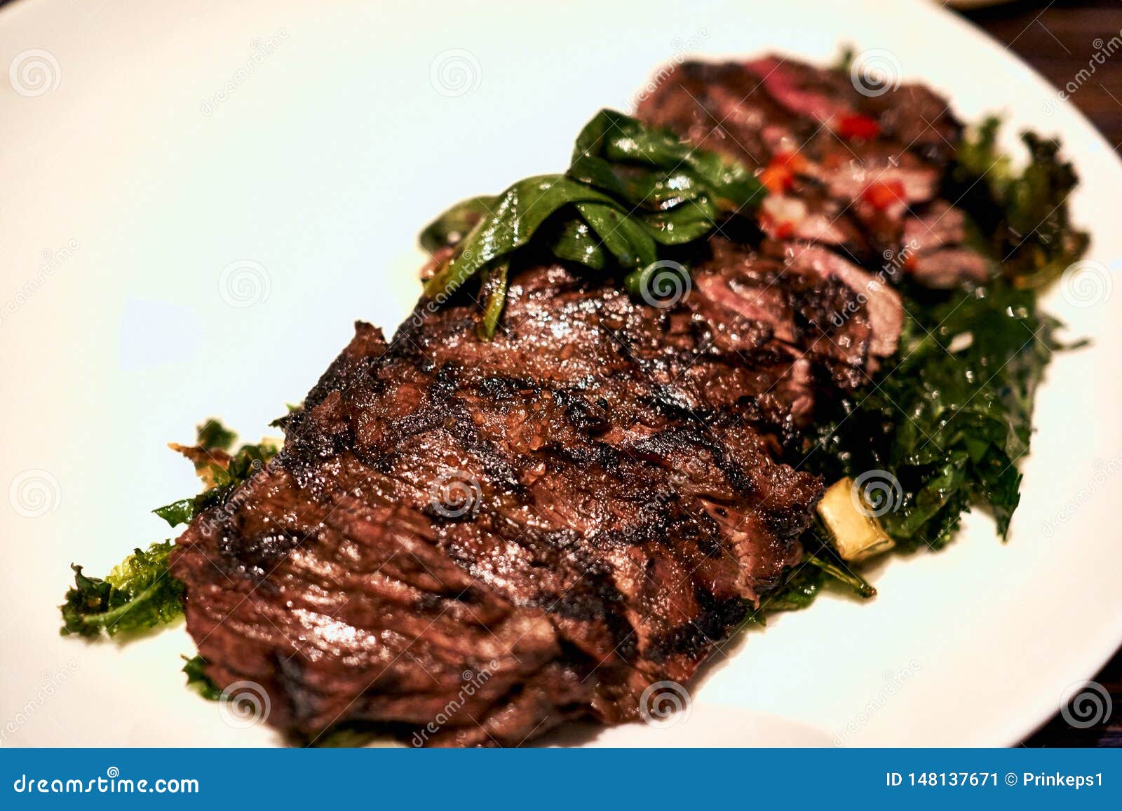 Juicy Steak with Assorted Vegetables on a White Plate at a Restaurant