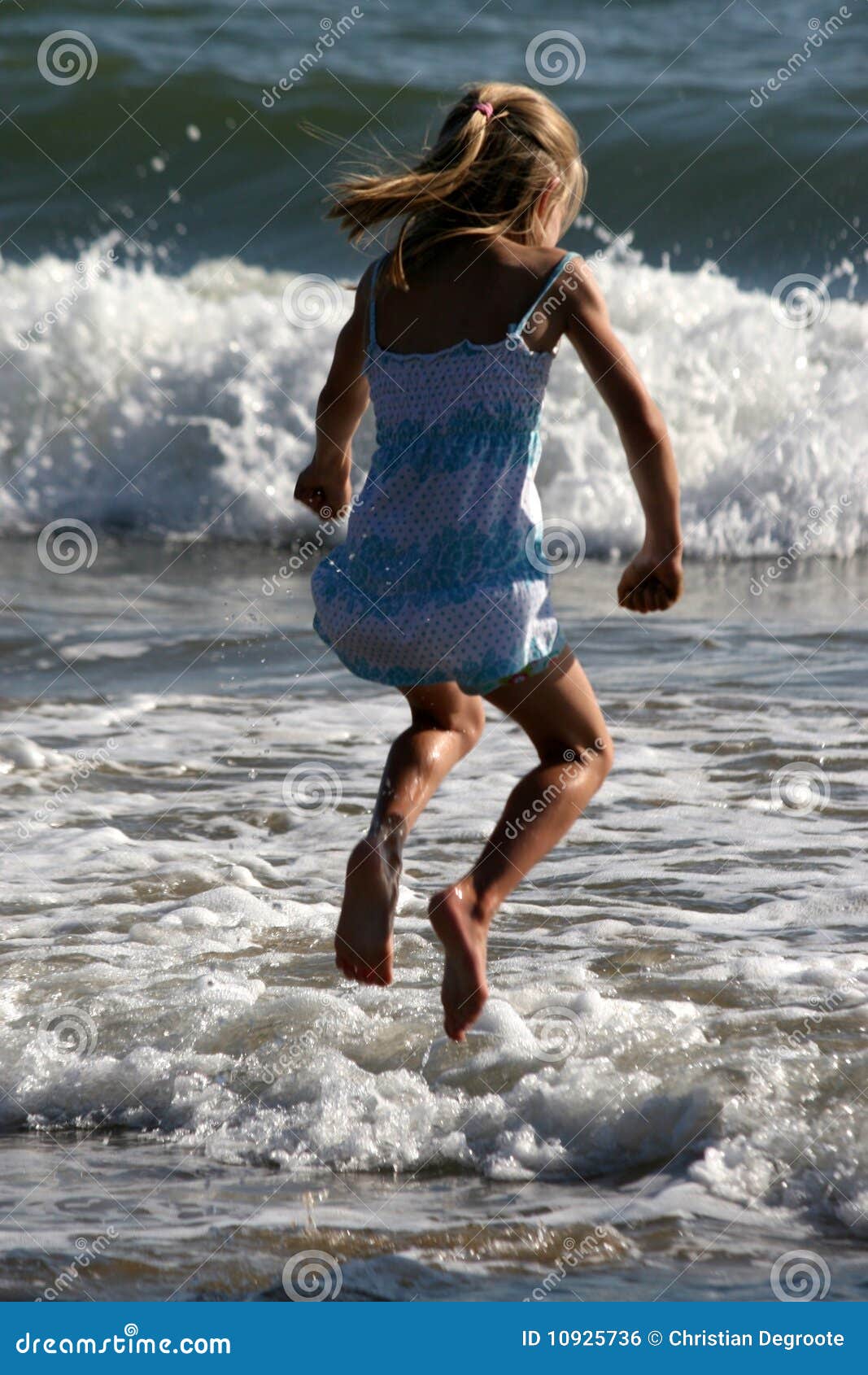 Jumping over the waves stock photo. Image of vacation 10925736