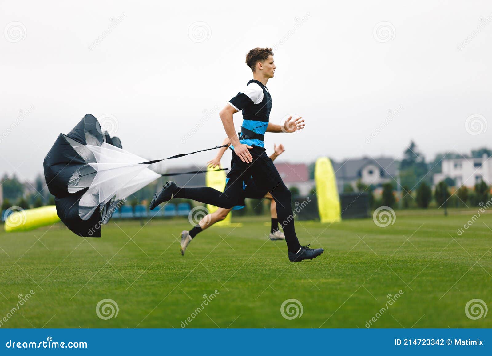 Junior Football Player Running with Parachute. Soccer Endurance