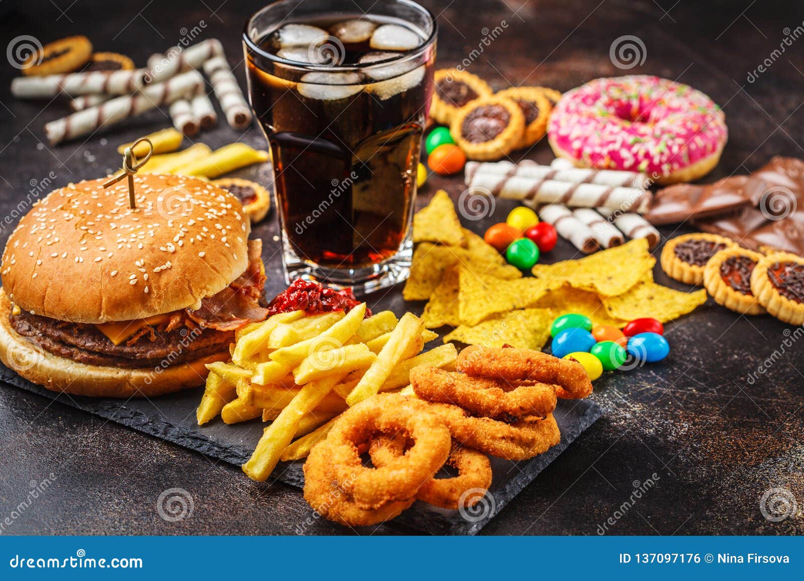 junk food concept. unhealthy food background. fast food and sugar. burger, sweets, chips, chocolate, donuts, soda