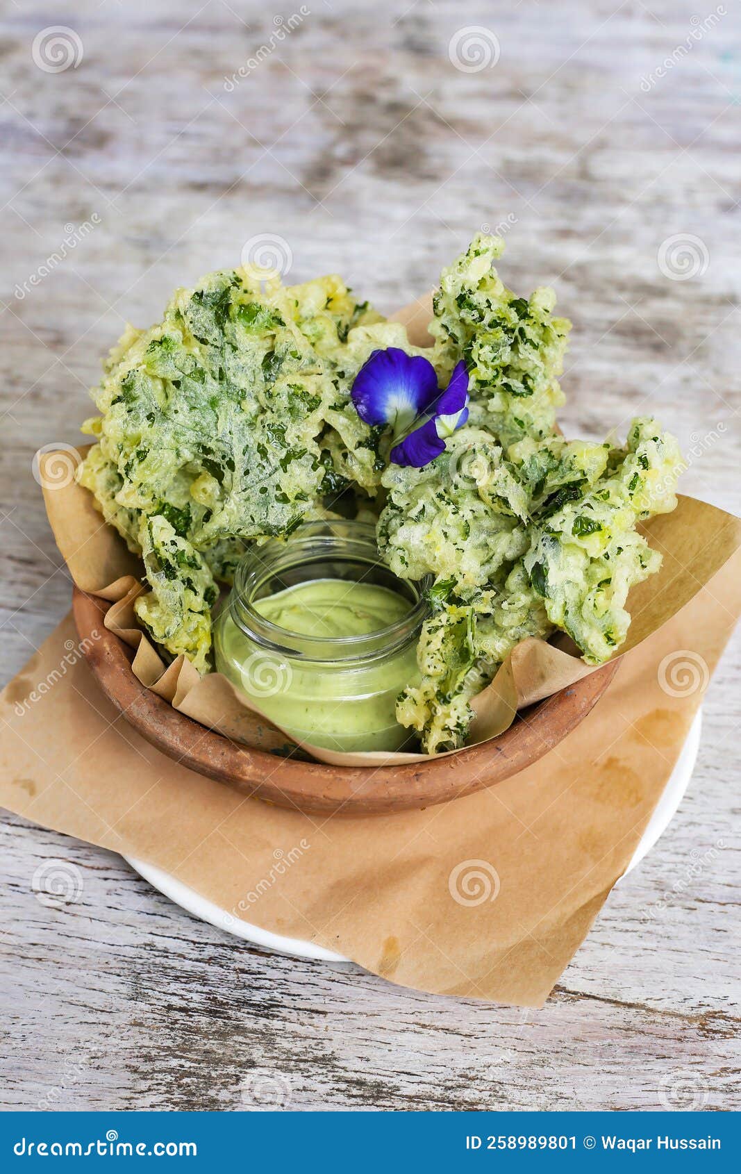 Kale Chips with Dip Served in a Dish Isolated on Grey Background Side