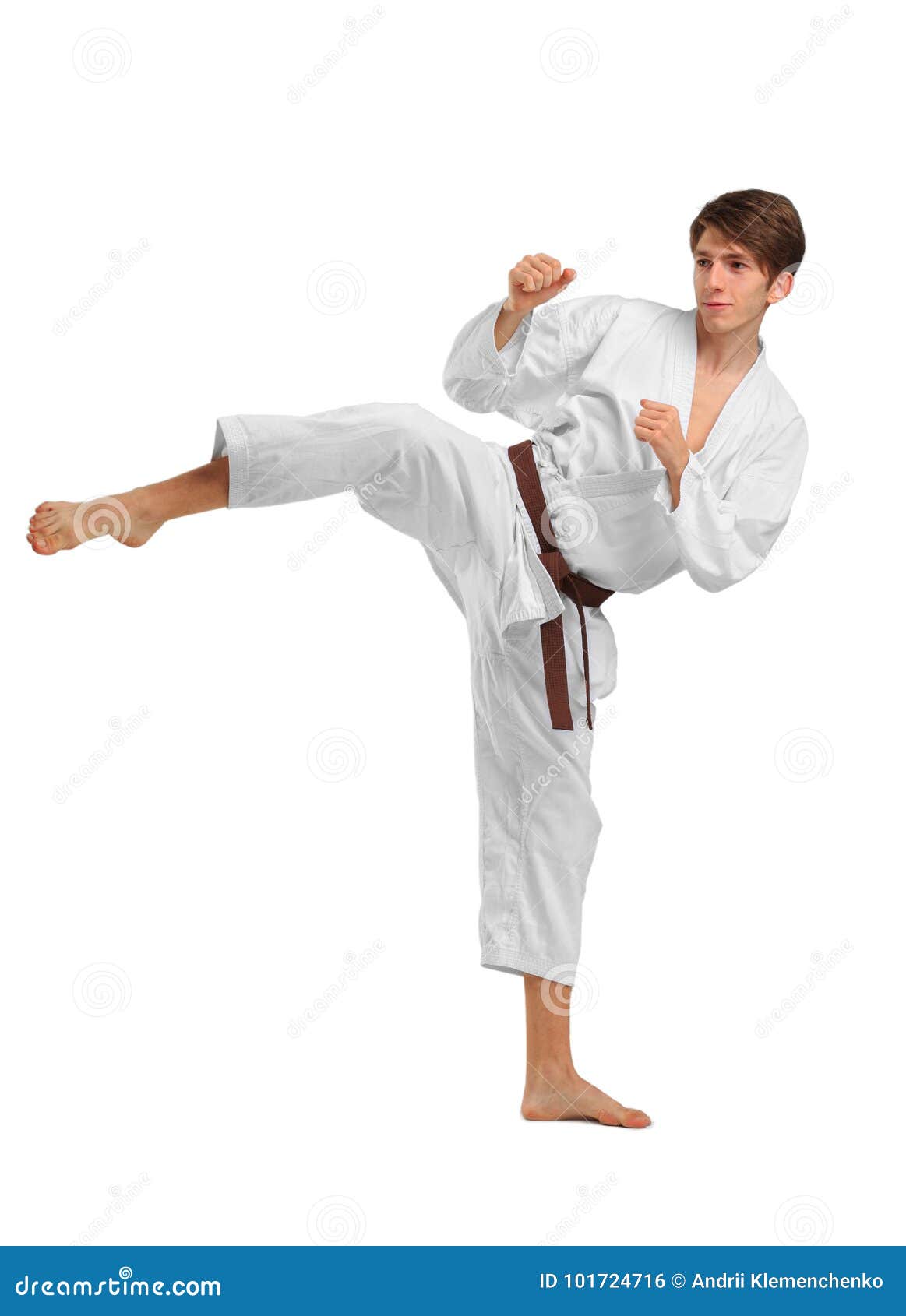 karate. a man is performing a punch.  on white background.